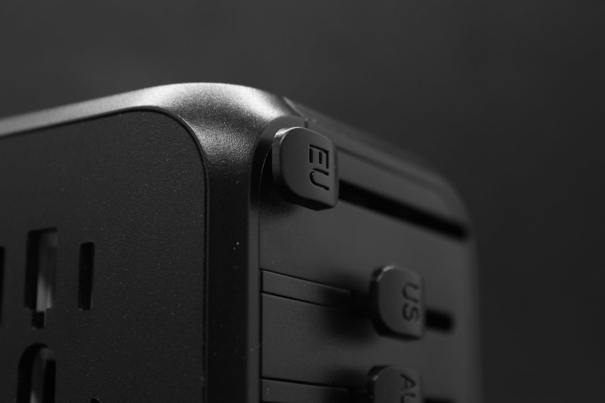 Hoekperspectief van de ELEKSO stekker met duidelijk zicht op schuifknoppen voor wereldwijde compatibiliteit.